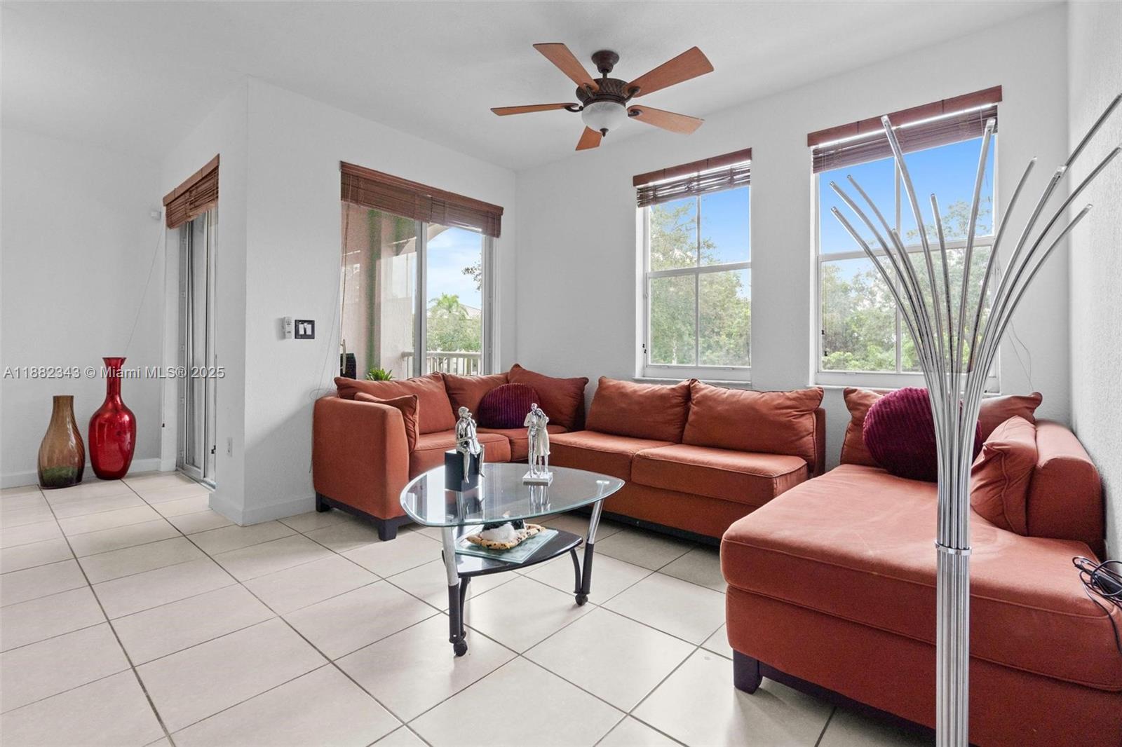 4455 Southwest 160th Avenue, Unit 205 Miramar, FL 33027 - Photo 2 of 44 a living room with furniture a fireplace and a large window