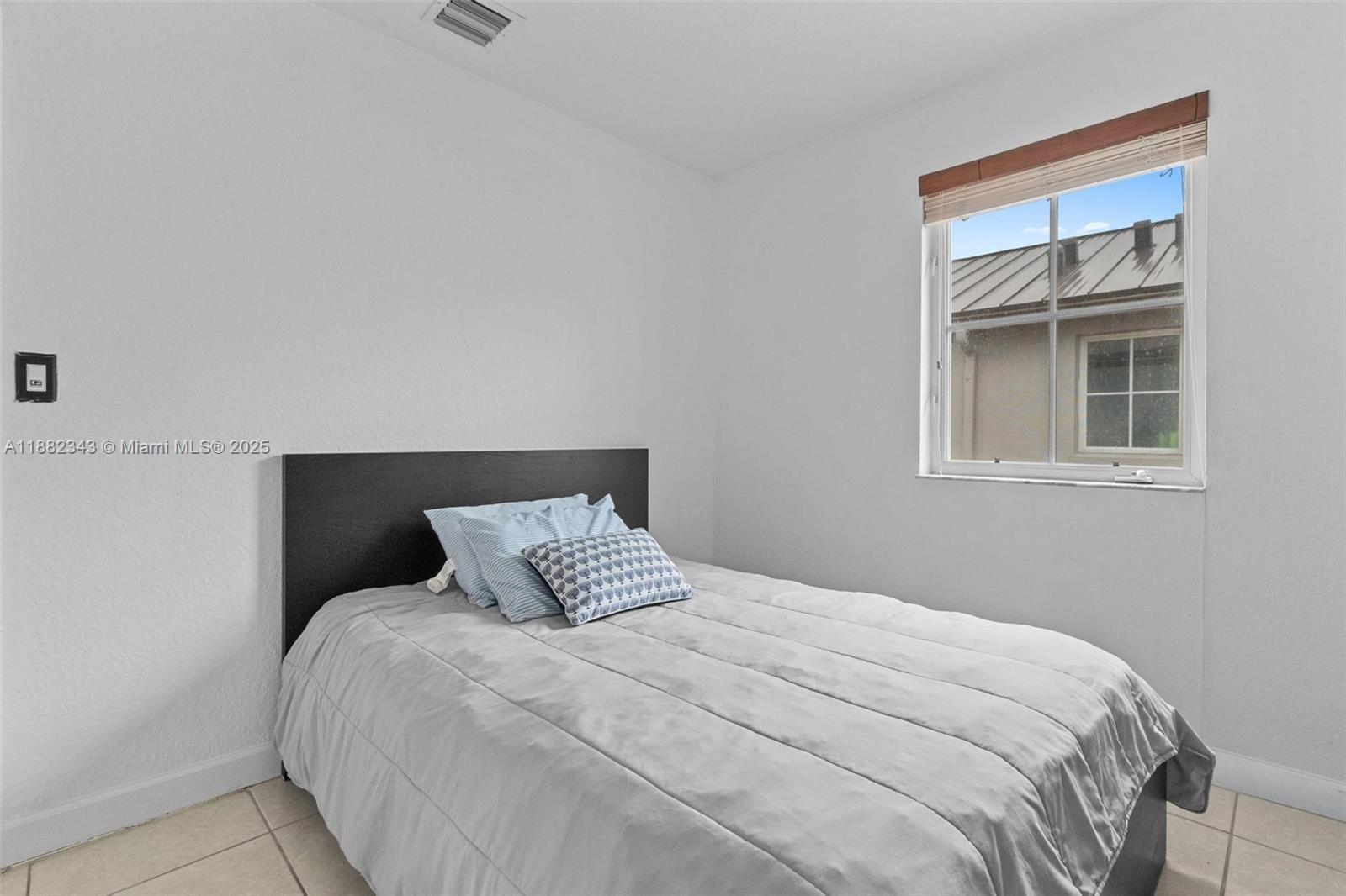 4455 Southwest 160th Avenue, Unit 205 Miramar, FL 33027 - Photo 21 of 44 a bedroom with a bed and a window