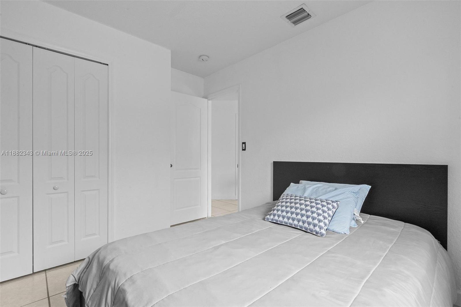 4455 Southwest 160th Avenue, Unit 205 Miramar, FL 33027 - Photo 22 of 44 a bedroom with a bed and a night stand