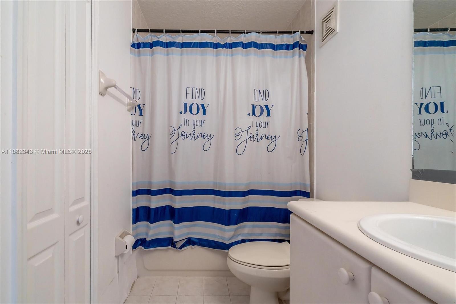 4455 Southwest 160th Avenue, Unit 205 Miramar, FL 33027 - Photo 23 of 44 a bathroom with a toilet and a shower curtain