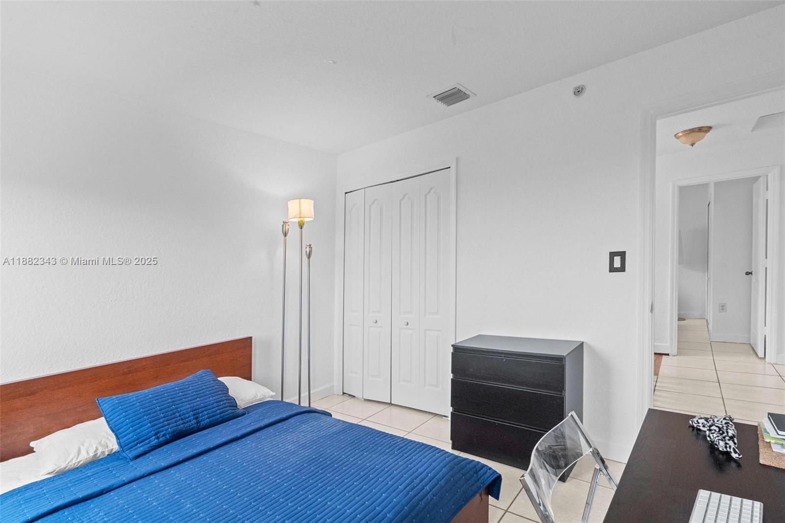 4455 Southwest 160th Avenue, Unit 205 Miramar, FL 33027 - Photo 28 of 44 a bedroom with a bed and a chair