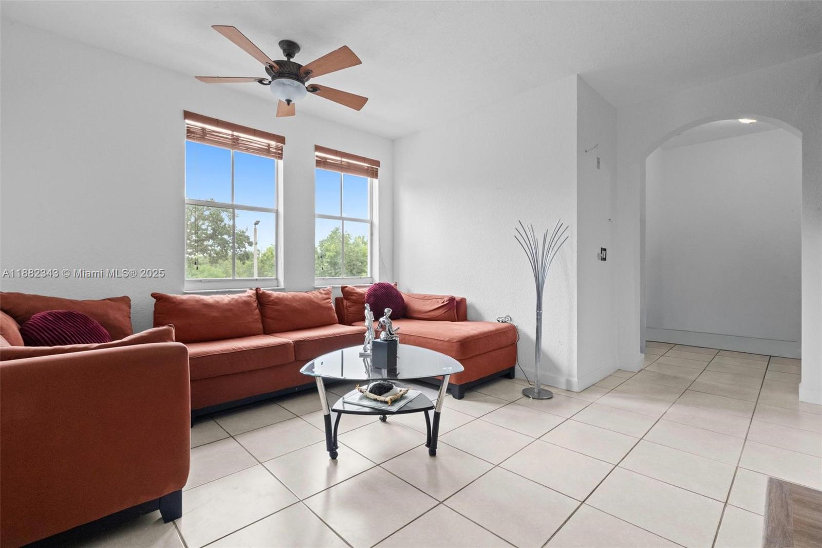 4455 Southwest 160th Avenue, Unit 205 Miramar, FL 33027 - Photo 3 of 44 a living room with furniture a chandelier and a window