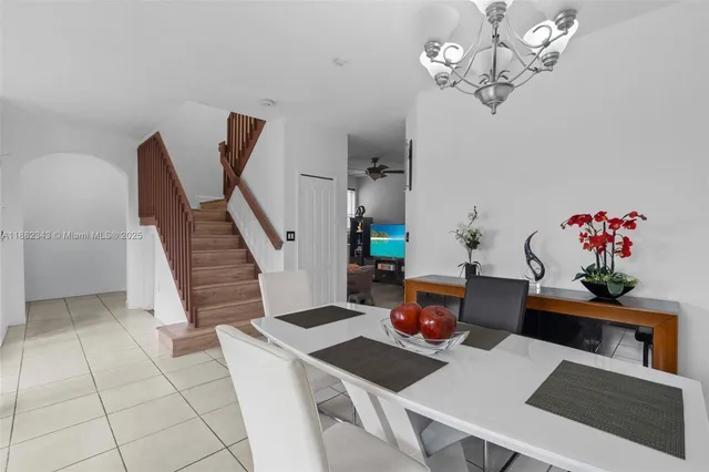 a view of a dining room with furniture and chandelier
