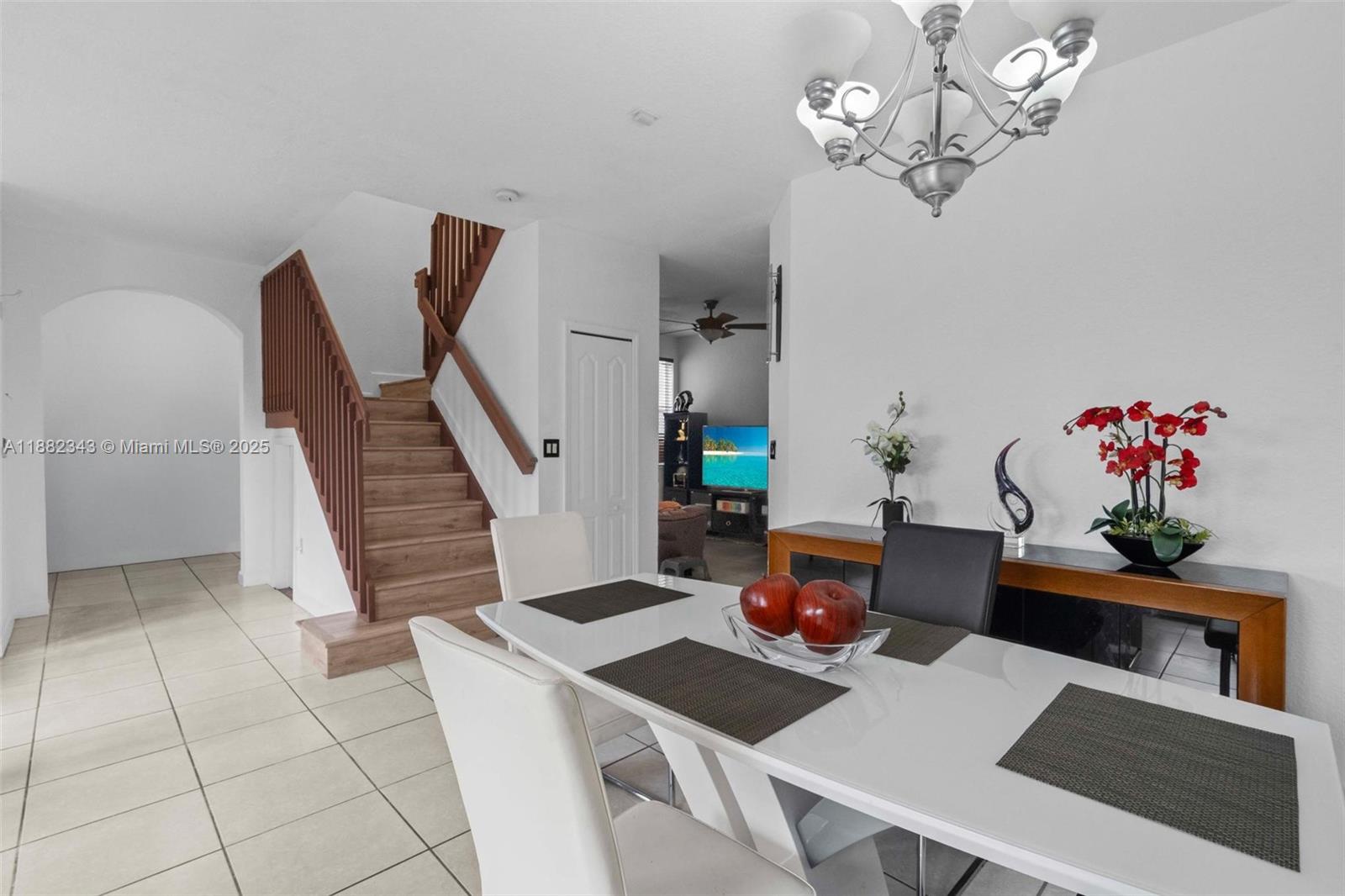 4455 Southwest 160th Avenue, Unit 205 Miramar, FL 33027 - Photo 8 of 44 a view of a dining room with furniture and chandelier