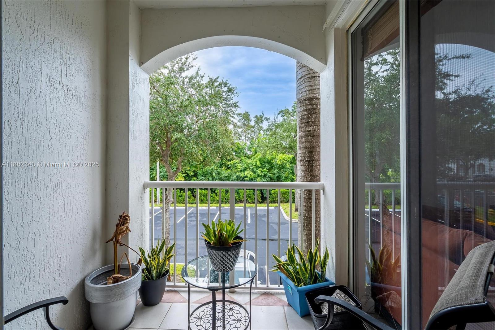 4455 Southwest 160th Avenue, Unit 205 Miramar, FL 33027 - Photo 10 of 44 a view of a balcony with chairs and a potted plant