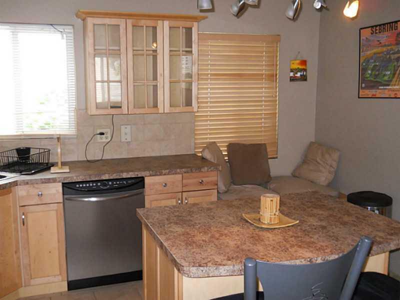 a kitchen with stainless steel appliances granite countertop a sink and a granite counter tops