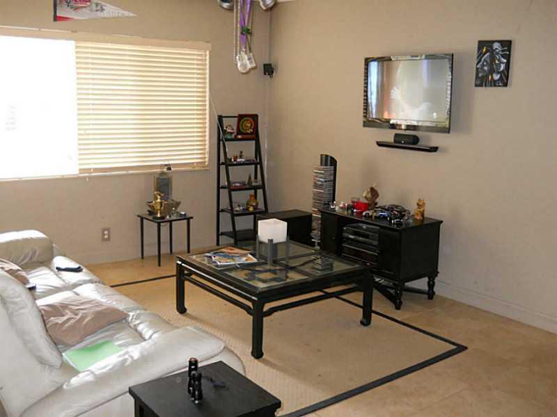 520 Southwest 15th Street, Unit 101 Pompano Beach, FL 33060 - Photo 2 of 9 a living room with furniture and a window