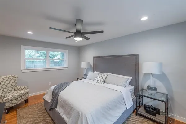 a bedroom with a bed and a window