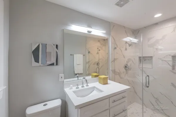 a bathroom with a sink vanity granite and a mirror