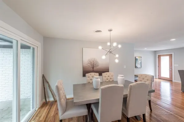 a view of a dining room with furniture and wooden floor