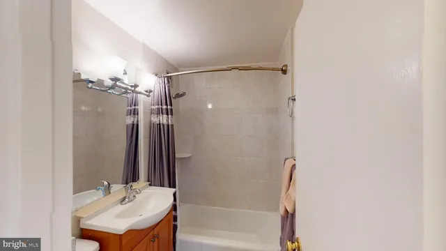 a bedroom with a bed a mirror and a large window