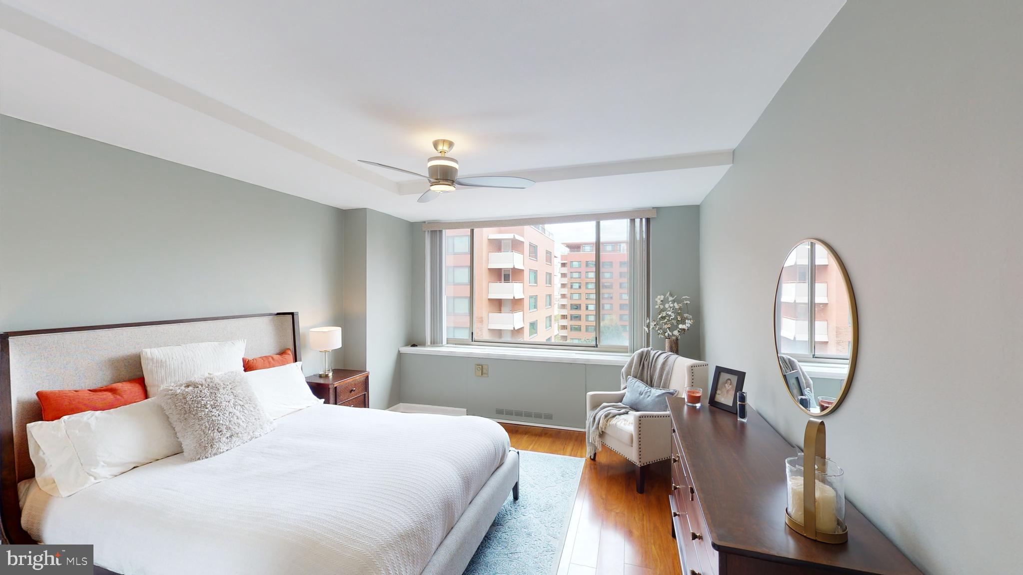 1111 Arlington Boulevard, Unit 731 Arlington, VA 22209 - Photo 17 of 46 a bedroom with a bed a mirror and a large window