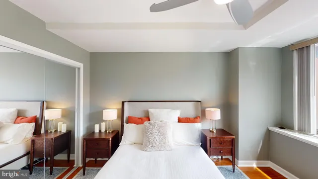 a bedroom with a bed mirror and a window