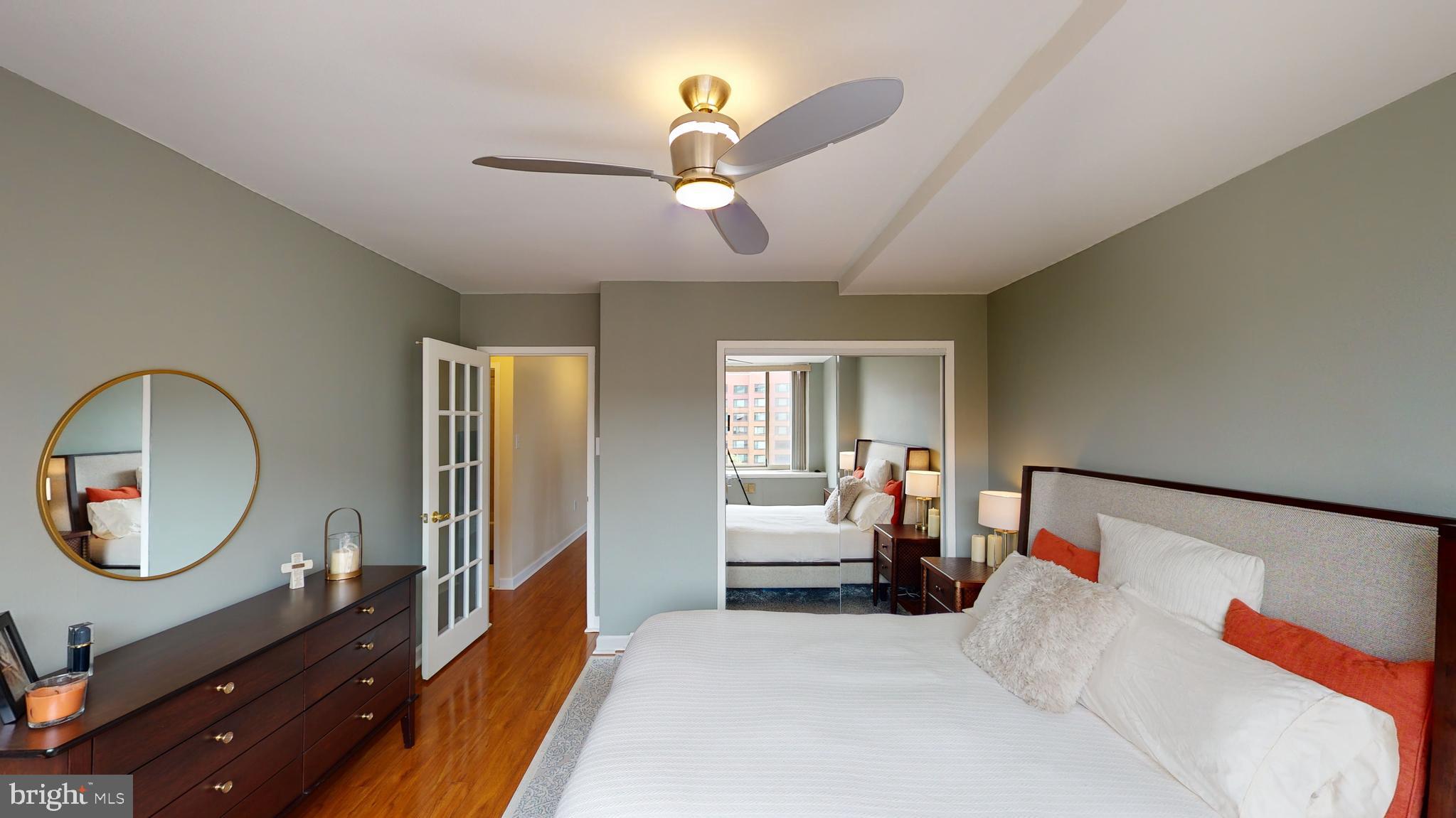 1111 Arlington Boulevard, Unit 731 Arlington, VA 22209 - Photo 20 of 46 a bedroom with a bed mirror and a window