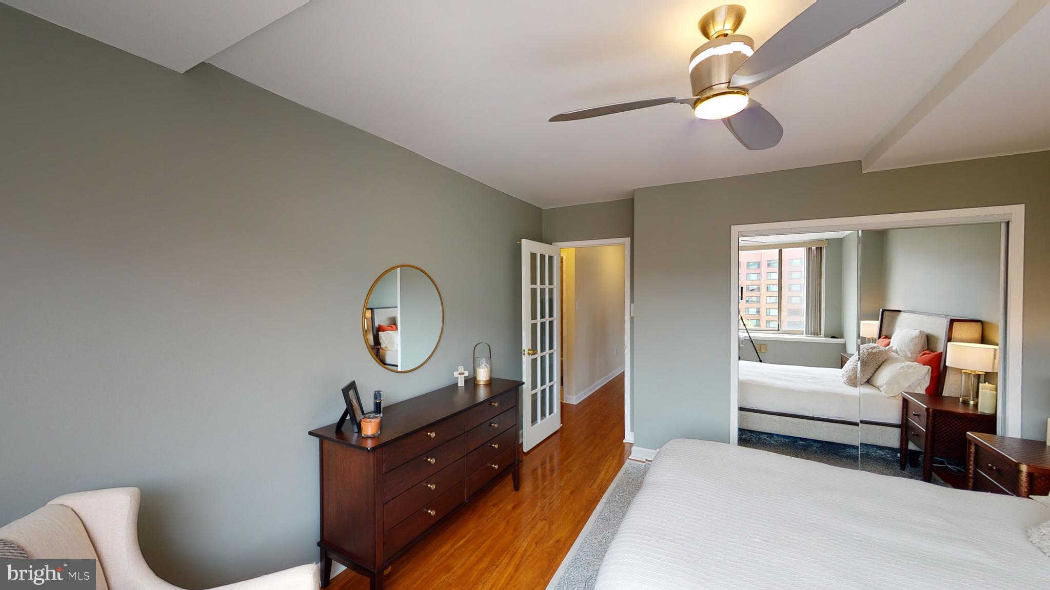 1111 Arlington Boulevard, Unit 731 Arlington, VA 22209 - Photo 21 of 46 a living room with furniture a mirror and a chandelier
