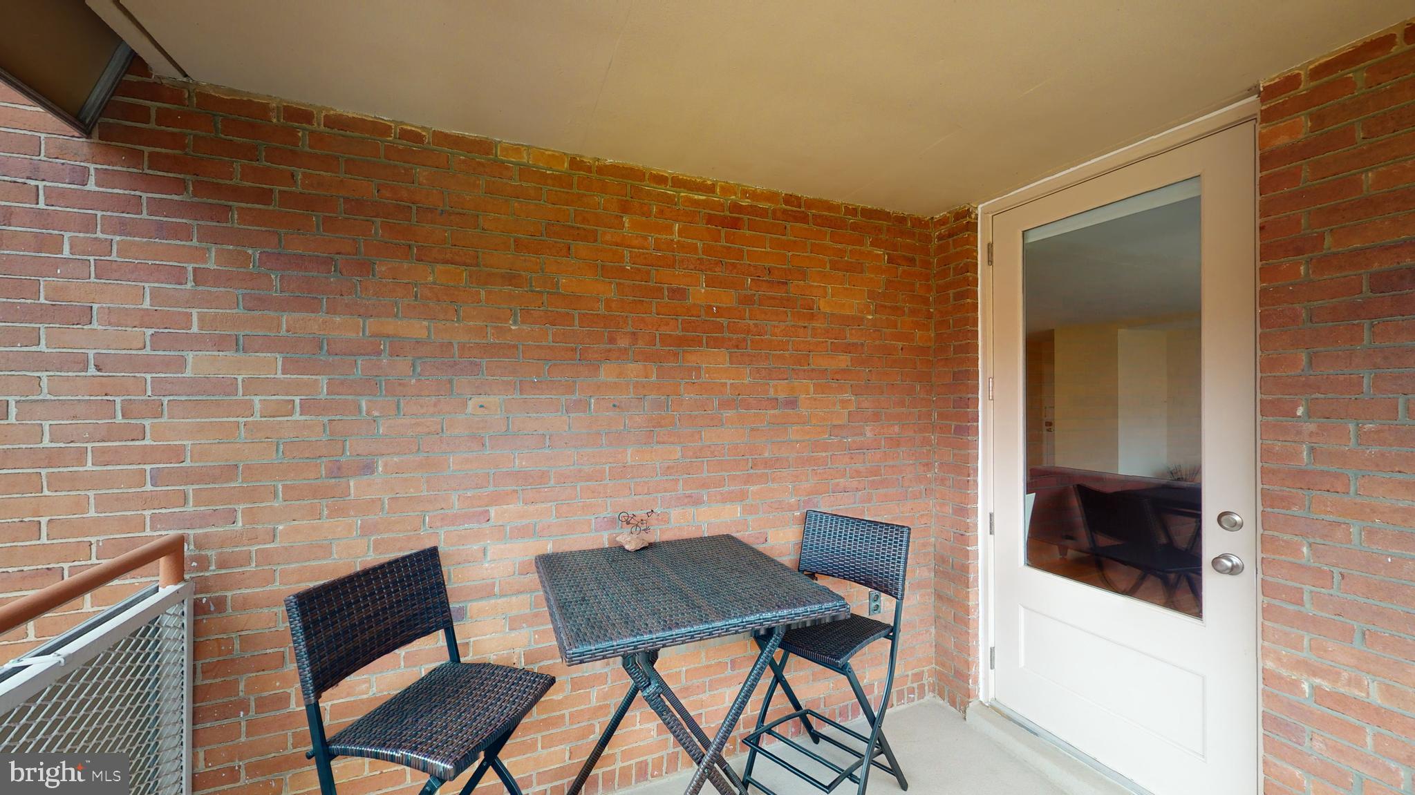 1111 Arlington Boulevard, Unit 731 Arlington, VA 22209 - Photo 22 of 46 a balcony with table and chairs