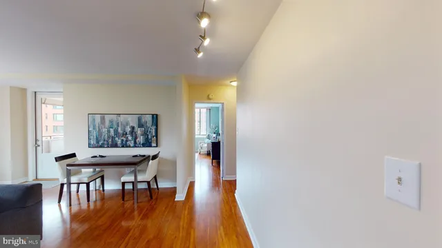 a dining room with furniture and wooden floor