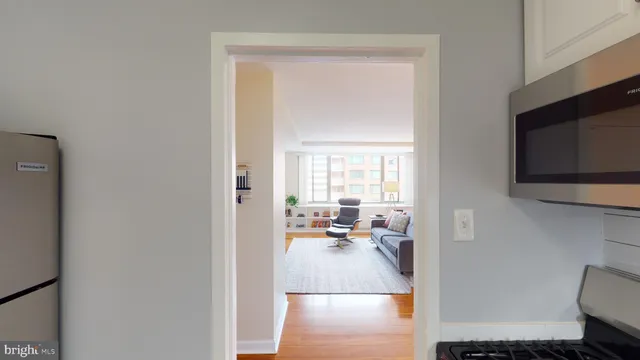 a kitchen with granite countertop a refrigerator and cabinets