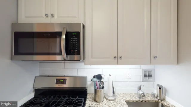 a kitchen with sink and cabinets