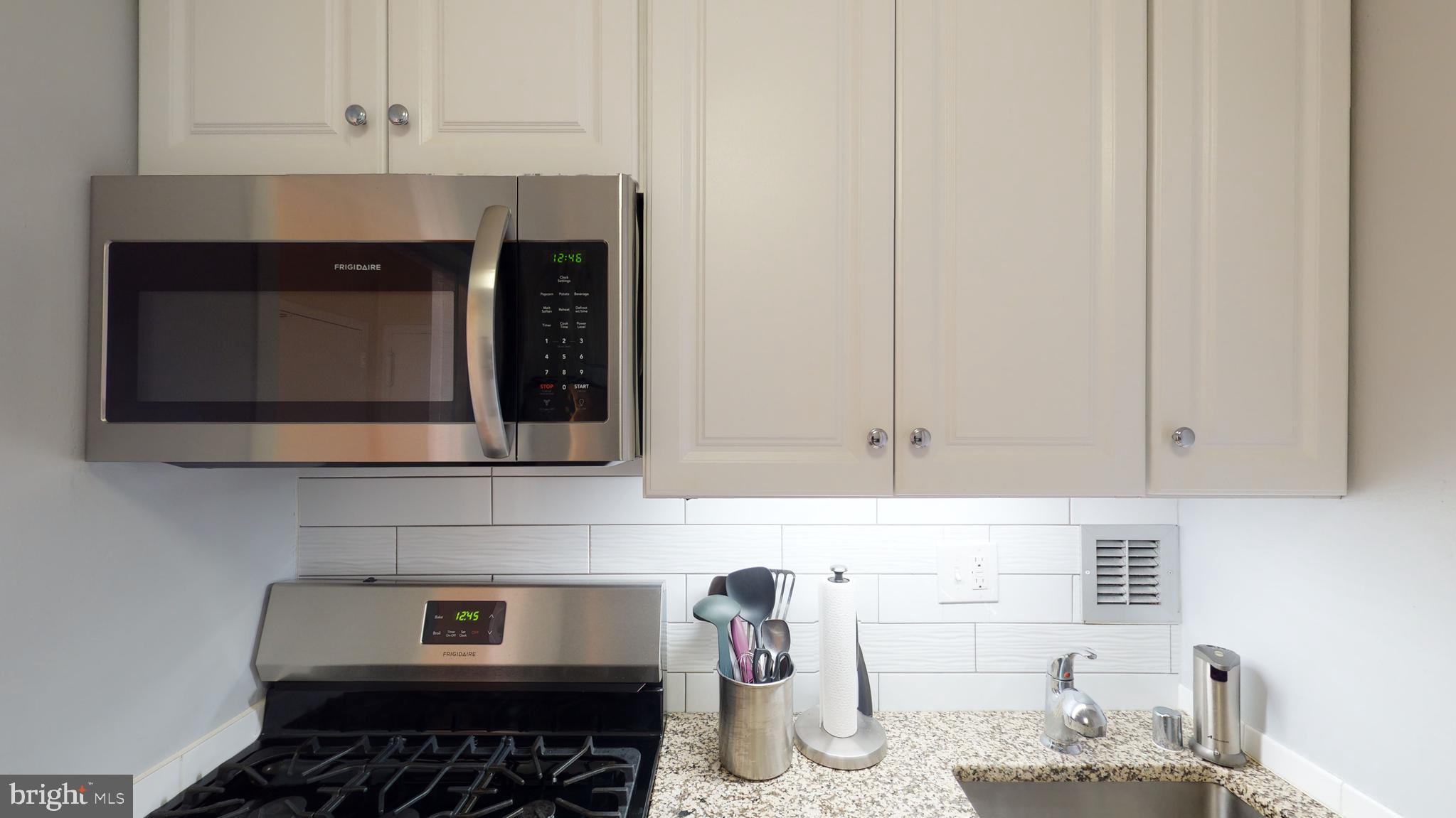 1111 Arlington Boulevard, Unit 731 Arlington, VA 22209 - Photo 9 of 46 a kitchen with a stove and cabinets