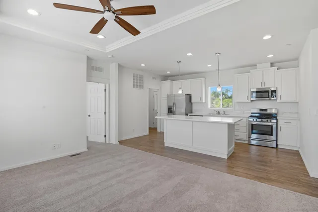 a view of kitchen with refrigerator cabinets and a ceiling fan