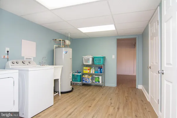 a view of a kitchen with wooden floor and electronic appliances