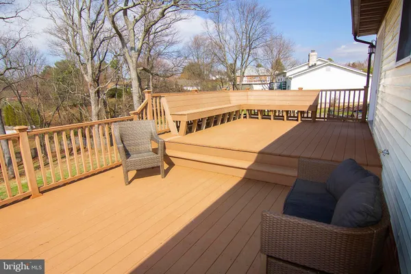 a view of a balcony with wooden floor and fence
