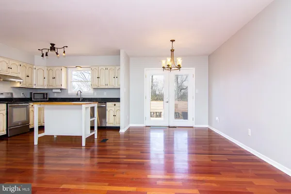 a view of a kitchen with granite countertop cabinets counter top space and stainless steel appliances
