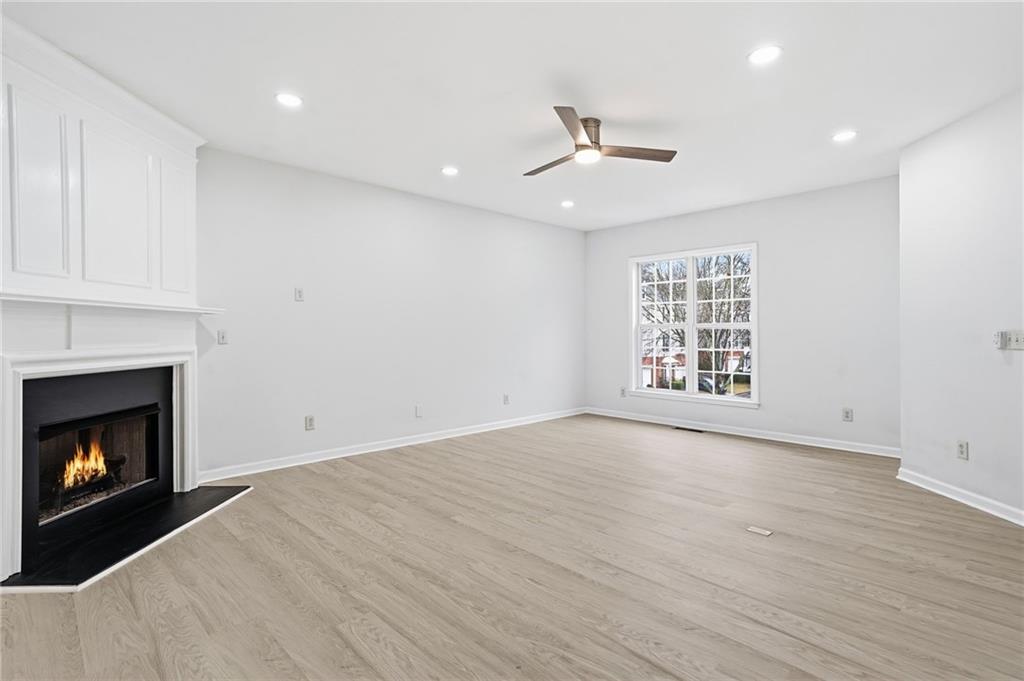 3349 Lathenview Court Alpharetta, GA 30004 - Photo 12 of 48 a view of an empty room with a fireplace and a window