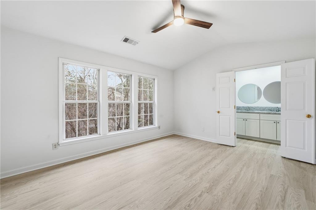 3349 Lathenview Court Alpharetta, GA 30004 - Photo 14 of 48 a view of an empty room with a window and wooden floor