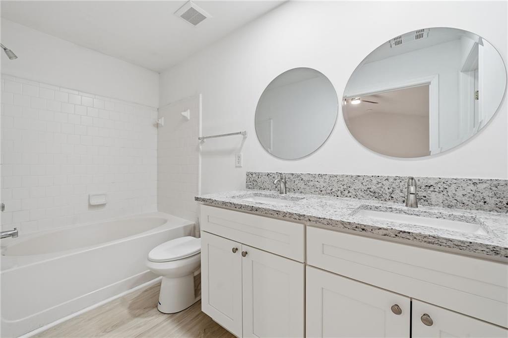 3349 Lathenview Court Alpharetta, GA 30004 - Photo 17 of 48 a bathroom with a granite countertop toilet sink and mirror