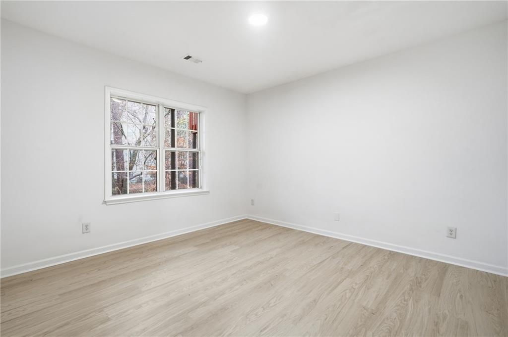 3349 Lathenview Court Alpharetta, GA 30004 - Photo 23 of 48 an empty room with wooden floor and windows