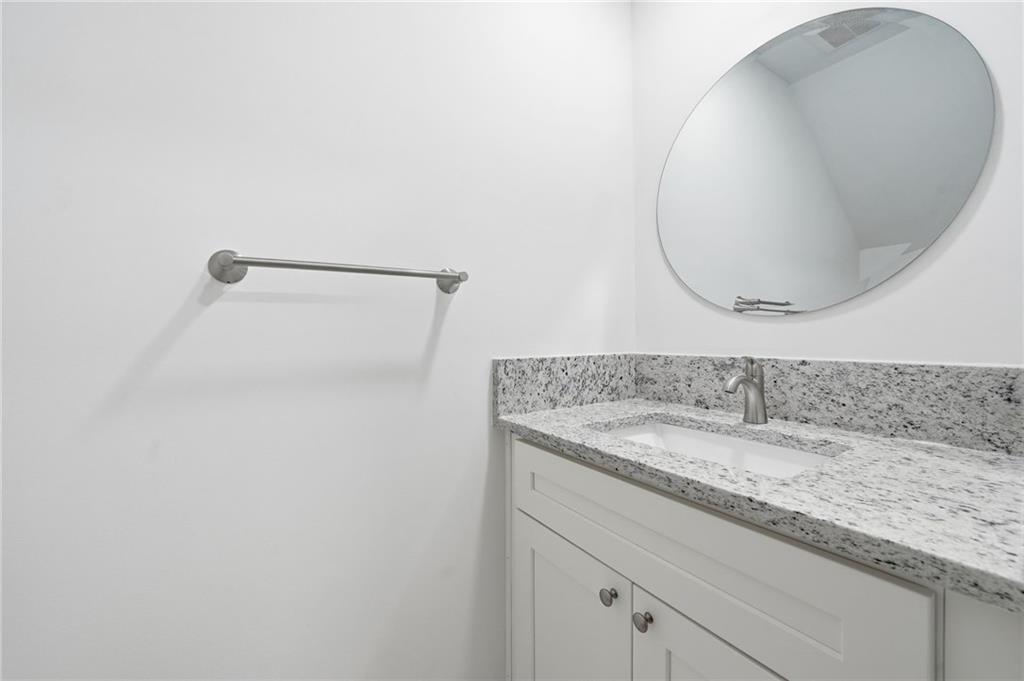 3349 Lathenview Court Alpharetta, GA 30004 - Photo 25 of 48 a bathroom with a granite countertop sink and a mirror