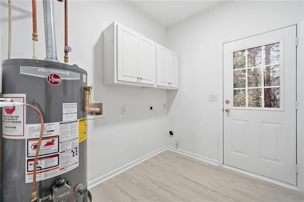 3349 Lathenview Court Alpharetta, GA 30004 - Photo 26 of 48 a view of storage and utility room with fridge and workspace