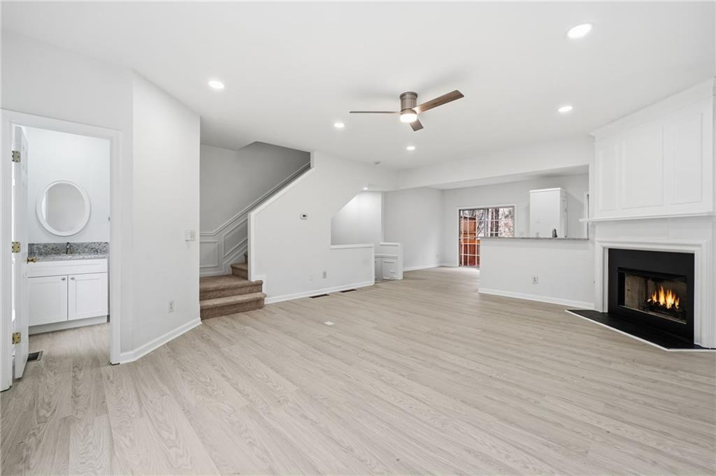 3349 Lathenview Court Alpharetta, GA 30004 - Photo 10 of 48 a view of empty room with wooden floor and fireplace