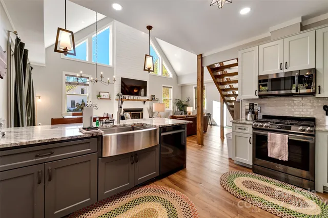 a spacious bedroom with a bed and a chandelier