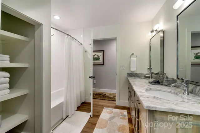 a spacious bedroom with a bed and a flat screen tv