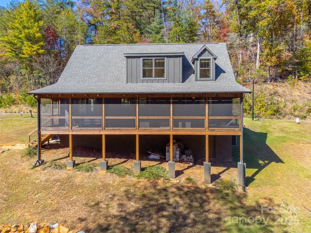 a view of a house with backyard porch and sitting area