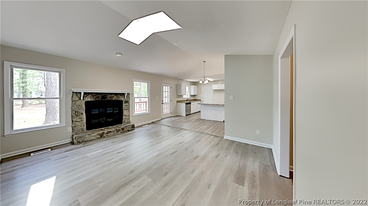 1759 Rim Road Fayetteville, NC 28314 - Photo 3 of 15 an empty room with fireplace and wooden floor