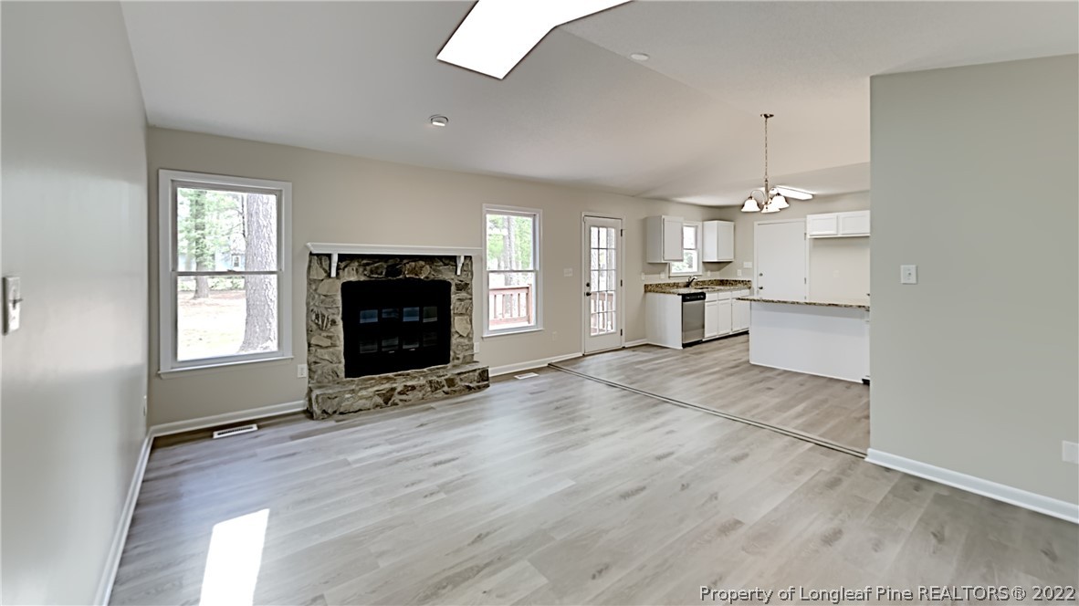 1759 Rim Road Fayetteville, NC 28314 - Photo 4 of 15 an empty room with kitchen and fireplace