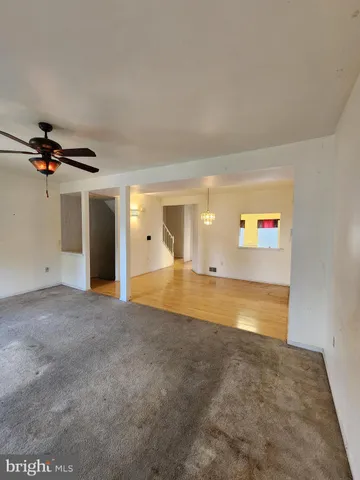 a view of a room with a ceiling fan