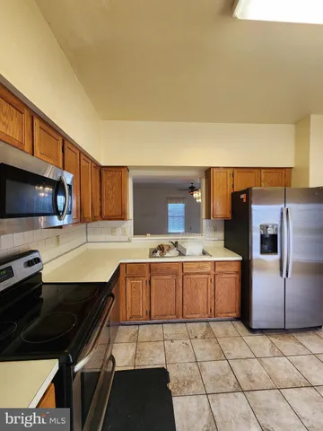 a kitchen with stainless steel appliances a stove a sink and a refrigerator