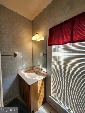 a bathroom with a sink a vanity and a shower
