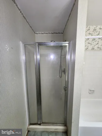 a bathroom with a bathtub and shower