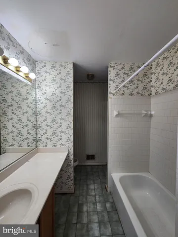 en empty room with windows and chandelier