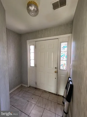 a view of a hallway to rooms and stairs