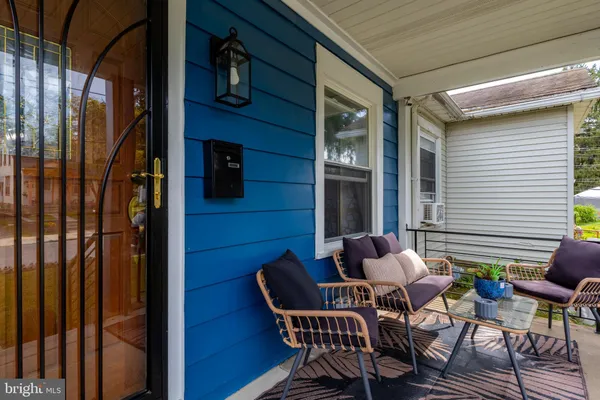 a couple of chairs sitting in front of a glass door
