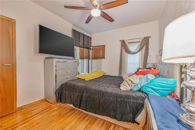 a bedroom with a bed mirror and a window