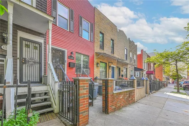 a view of a brick building with many windows