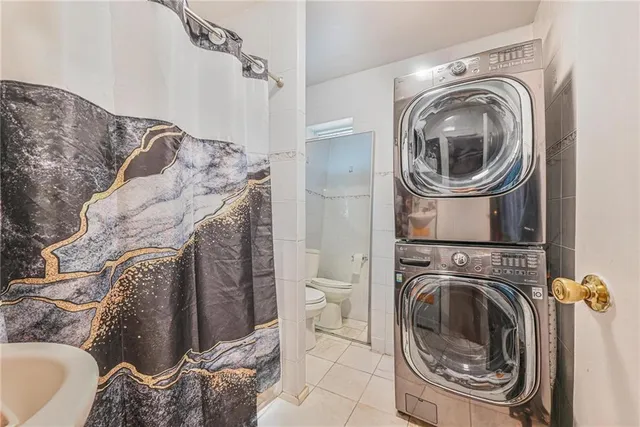 a utility room with bathtub and shower